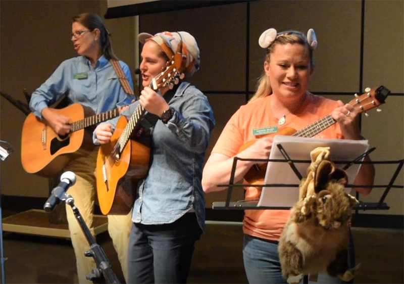 Robin, Michelle, and Catherine playing instruments at a Desert Museum singalong.